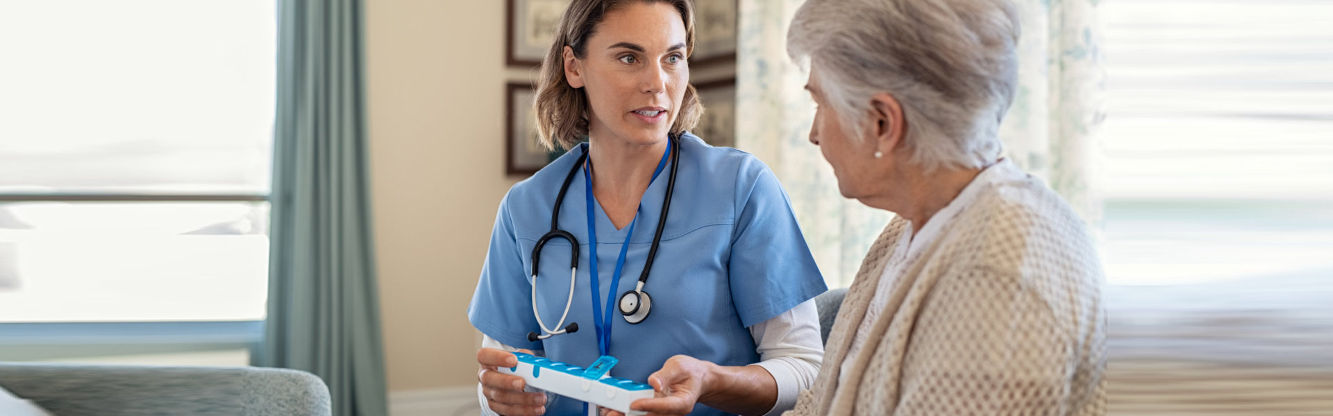 Nurse explaining medicine dosage to senior woman